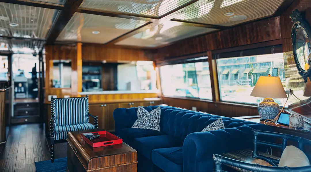 Full Circle Yacht remodeled interior lounge with blue couch