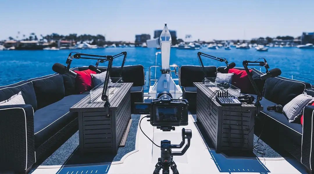 Dockside podcast recording setup with microphones and a camera on Full Circle Yacht's top deck