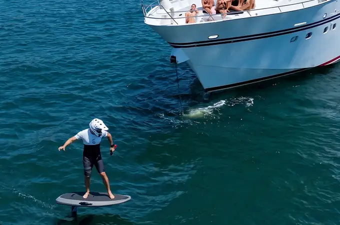 Paddle boarding beside the yacht