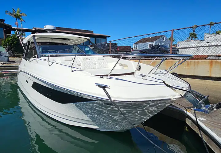 Front and side view of the white Sea Ray with dark hull windows
