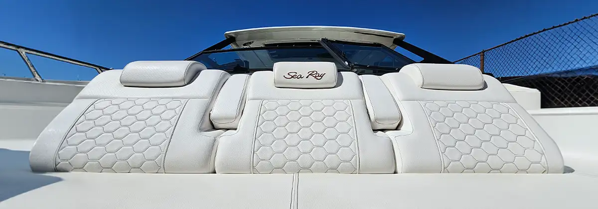 Close view of the white quilted bow cushions with Sea Ray embroidery