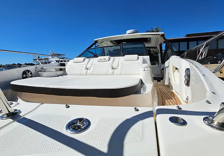 Cushioned lounge seating and stainless steel rails in the open bow of the Sea Ray