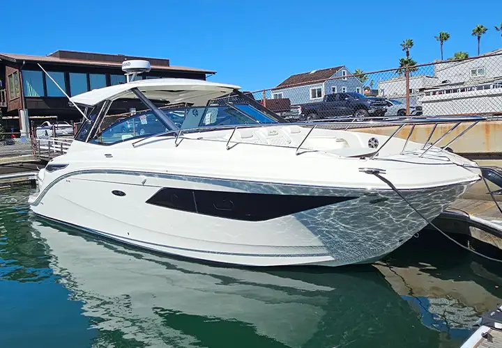 White Sea Ray docked in Newport Beach, viewed from the front and side