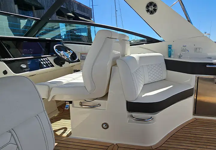 Upholstered helm seat with a bolster and armrest