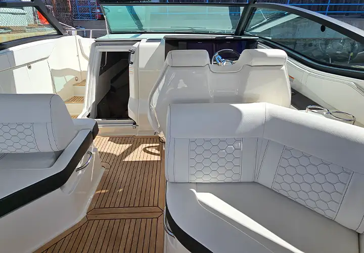 White cockpit seats and the passage toward the helm and cabin entrance